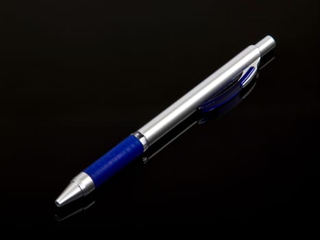 blue pen isolated on the black bacground