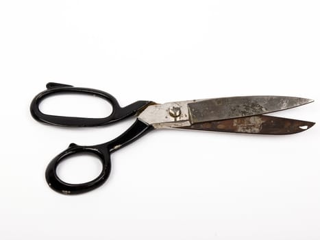 old black rusty scissors isolated on the white background