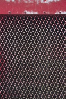 a distressed red metal grate pattern.