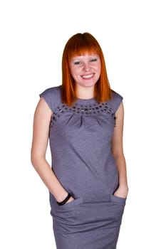 Happy young smiling redheaded woman in gray dress. Isolated over white background.