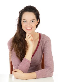 Isolated portrait of a happy young woman sitting at table