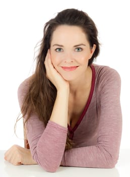 Isolated portrait of a relaxed lovely young woman sitting at a table