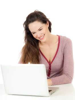 Portrait of a beautiful young happy woman using a laptop computer and laughing. Isolated on white.