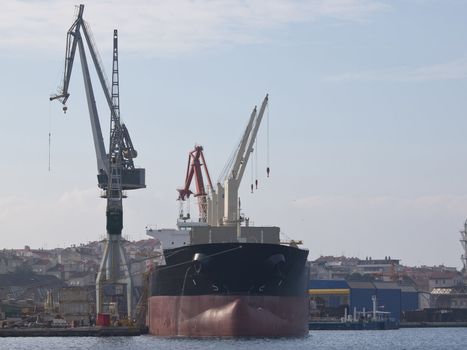 ship finishing in shipyard and two cranes