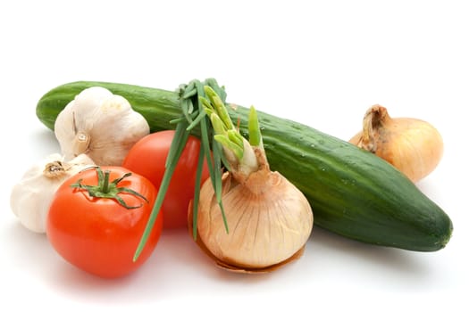 Vegetables, cucumber, tomatoes, onions, garlic on white background