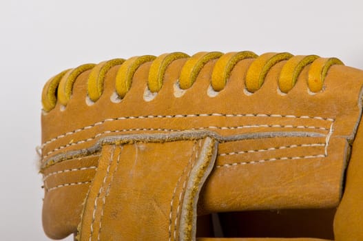 stiching on the brown leather baseball glove