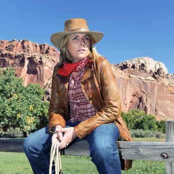 portrait of a long-haired blond young woman wearing a cowboy hat