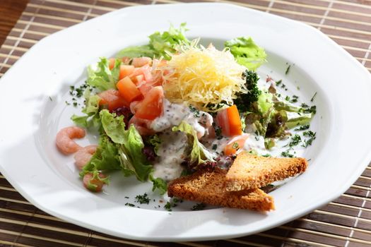 Fresh and tasty salad on the wooden table