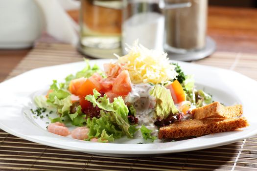 Fresh and tasty salad on the wooden table