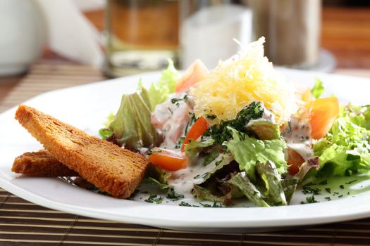 Fresh and tasty salad on the wooden table