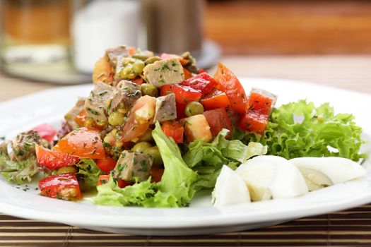 Fresh and tasty salad on the wooden table