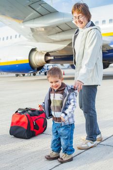 Smile beautiful cute boy and his grandmother prepared to fly