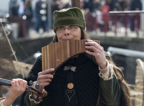 BRIELLE,HOLLAND APRIL 01:Woman playing panflute on the market on April 01, 2013 in Brielle,Holland.This is the party of the point in the uprising of Low Countries against Spain in the 80 Years' War

