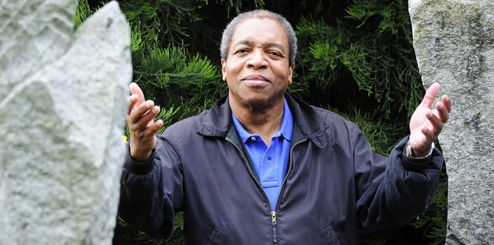 African American male posing outside.