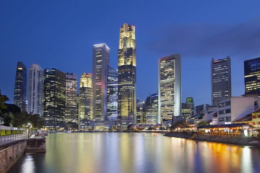 Singapore Central Business District (CBD) City Skyline by Boat Quay Along Singapore River at Blue Hour