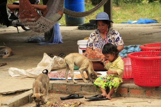 Mother and daughter sitting together under stilt house, Ream National Park, Cambodia, Southeast Asia