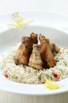 Chicken legs with rise in the white dish