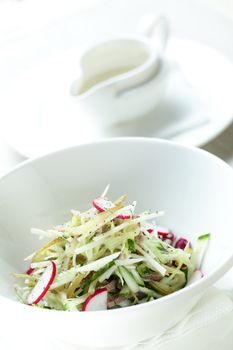 Fresh and tasty salad in white dish