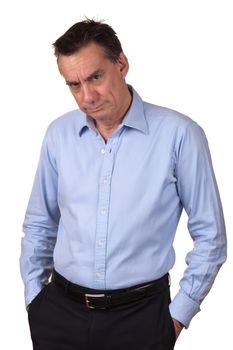 Angry Middle Age Man in Blue Shirt with Grumpy Expression and Hands in Pockets Isolated