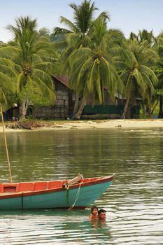 Father and child swimming together, Ream National Park, Cambodia, Southeast Asia