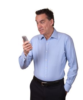 Attractive Middle Age Man in Blue Shirt Looking at Phone with Startled Expression Isolated