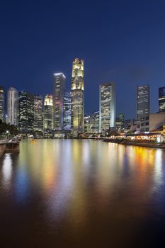 Singapore Central Business District (CBD) City Skyline by Boat Quay Along Singapore River at Blue Hour Vertical