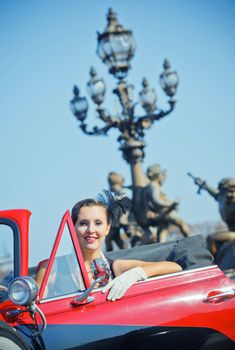 Romantic in Paris. Young happy woman in retro-style travel in a car in Paris