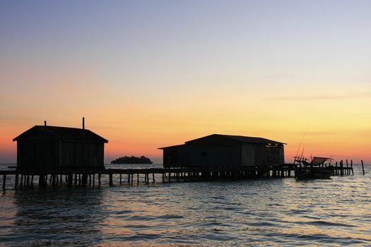 Silhouette of wooden jetty at sunrise, Koh Rong island, Cambodia, Southeast Asia