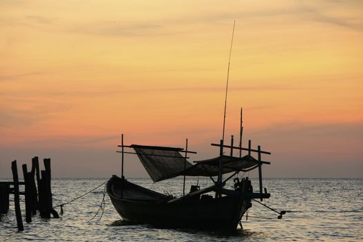 Silhouette of traditional fishing boat at sunrise, Koh Rong island, Cambodia, Southeast Asia