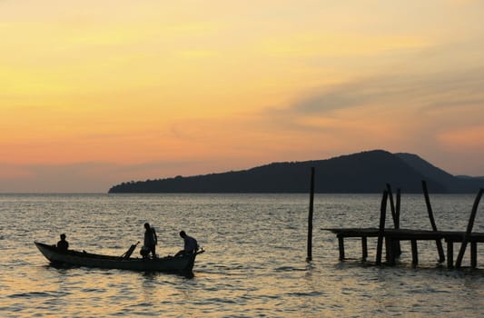 Silhouette of traditional fishing boat at sunrise, Koh Rong island, Cambodia, Southeast Asia