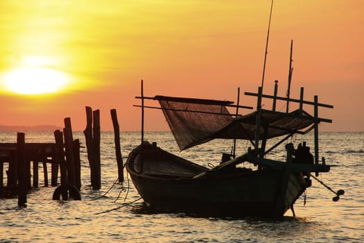 Silhouette of traditional fishing boat at sunrise, Koh Rong island, Cambodia, Southeast Asia