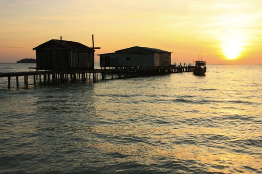 Silhouette of wooden jetty at sunrise, Koh Rong island, Cambodia, Southeast Asia