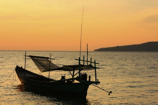 Silhouette of traditional fishing boat at sunrise, Koh Rong island, Cambodia, Southeast Asia