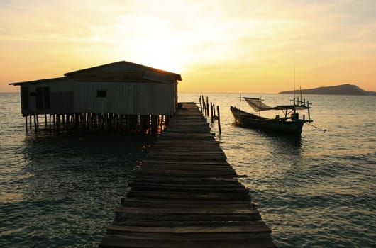 Silhouette of wooden jetty at sunrise, Koh Rong island, Cambodia, Southeast Asia