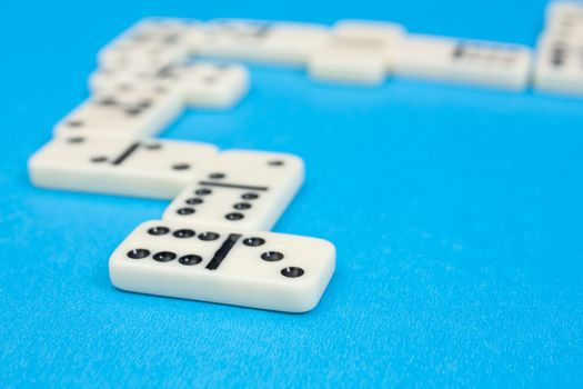 Closeup photo of domino bricks on blue background