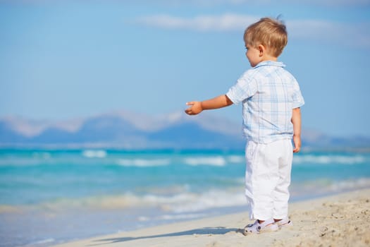 Little cute boy on the beautiful exotic white beach, Mallorca, Spain