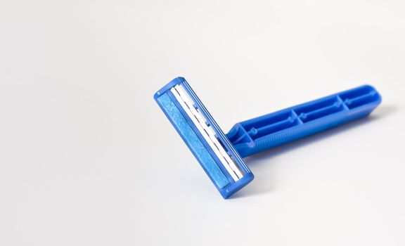 Close up photo of blue razor isolate on white background.