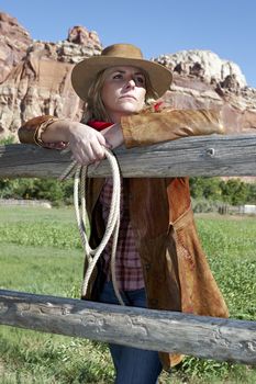 portrait of a beautiful lblond young woman wearing a cowboy hat