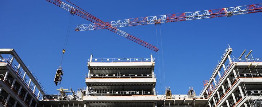 building site with crane and blue sky, panoramic view