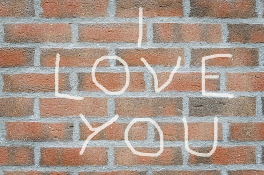 i love you inscription painted on a brick wall