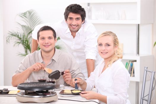 Friends eating raclette