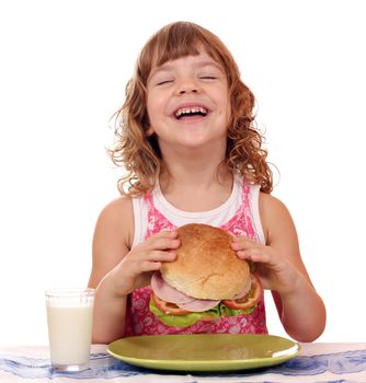 happy little girl eat big sandwich breakfast time