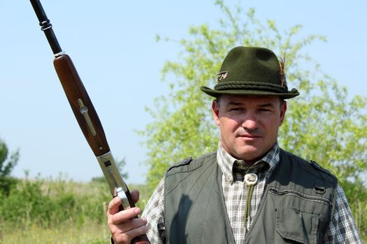 hunter with shotgun outdoor portrait