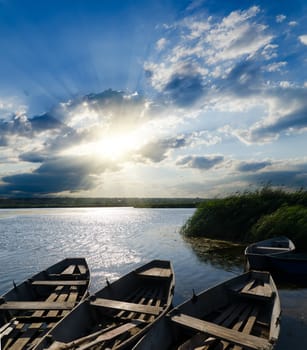 sunset over river with boats