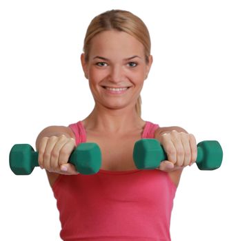 Young blonde woman doing exercise with dumbbells isolated against a white background.Selective focus on the dumbbells