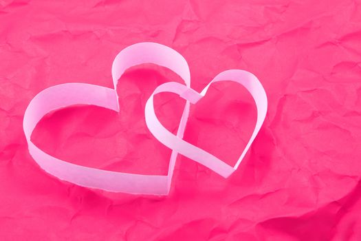 Paper hearts on pink background