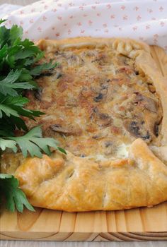 Tart with mushrooms in a creamy sauce with herbs close up