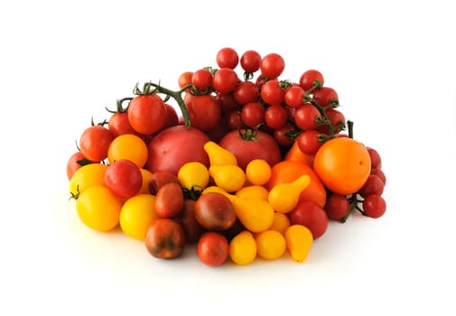 Group of tomatoes of different colors and varieties on a white background