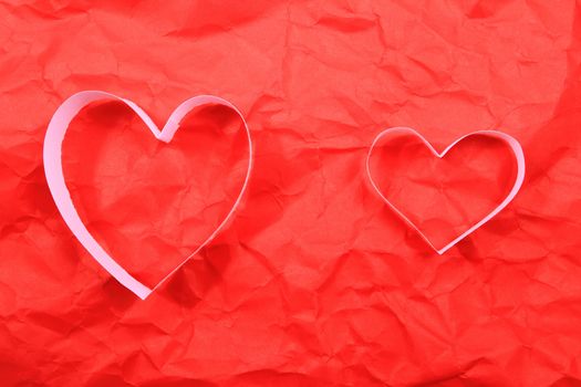 Paper hearts on red background