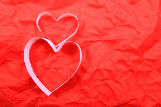 Paper hearts on red background